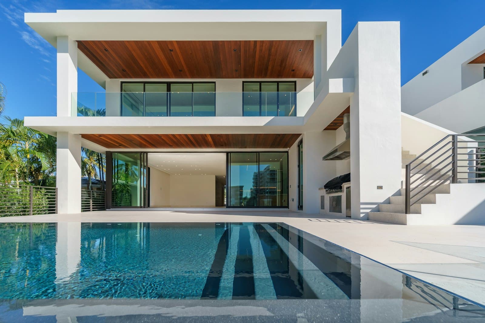 Luxury modern mansion with timber ceilings and a private pool at dusk, The Oasis by Emaar style
